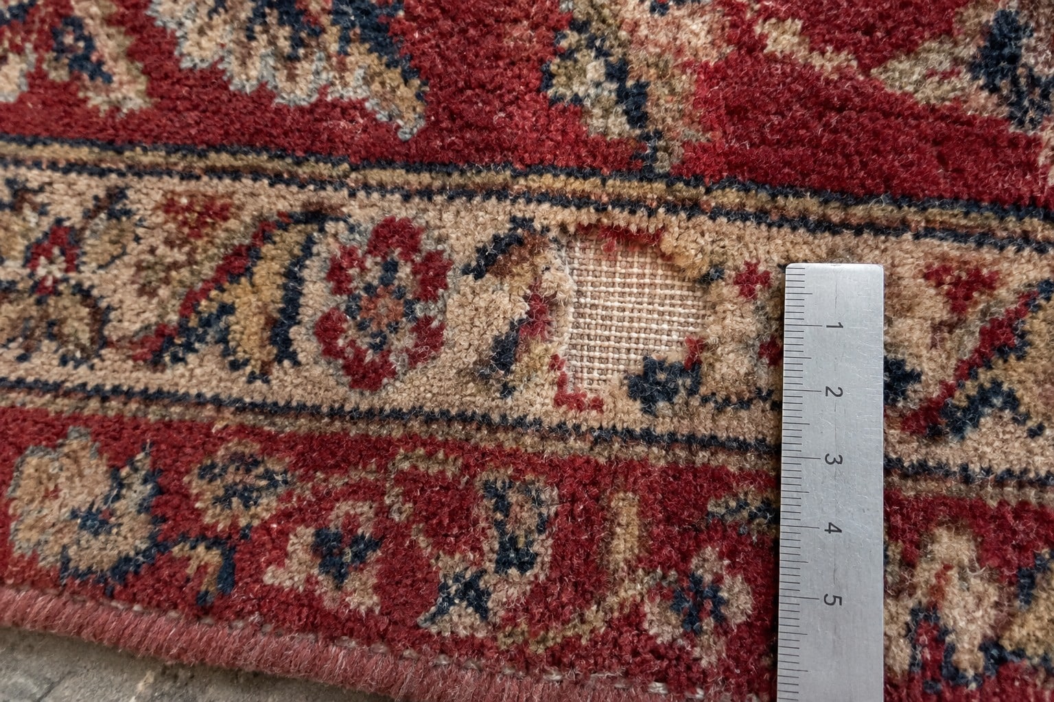 Illustrative scene showing a rug photographed beside a ruler